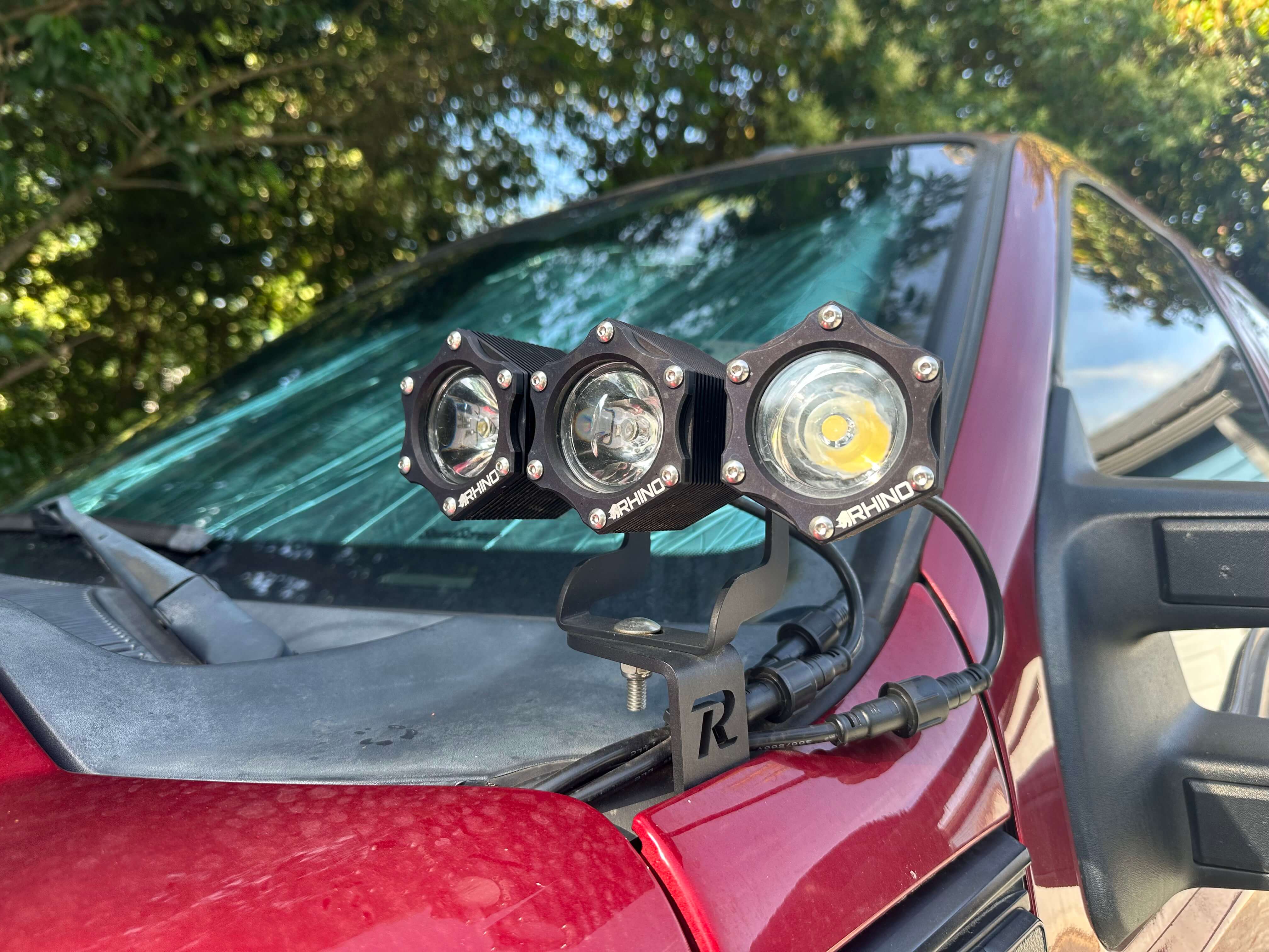 Three Rhino pod lights linked into one run on a vehicle cowl mount